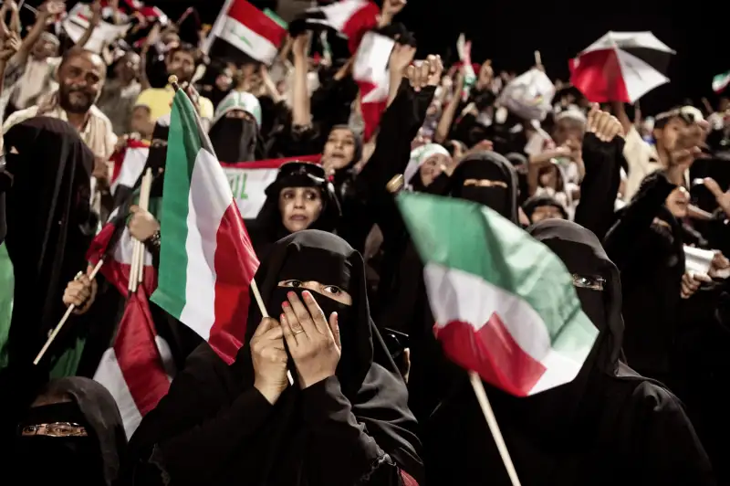 Fans attend a Gulf Cup soccer match between Iraq and Kuwait in Sanaa.