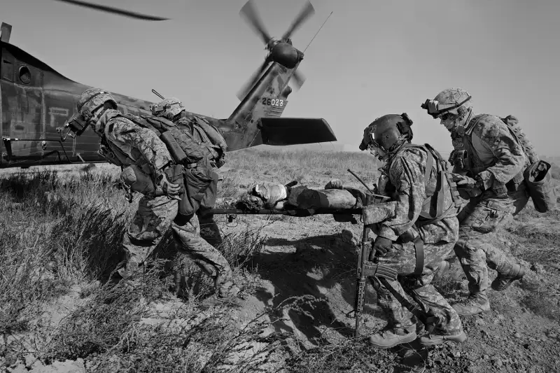 Members of Charlie Company of the 1-214th, known as Dustoff, rush to the aid of a Marine severely wounded by an IED in Marjah, Afghanistan.