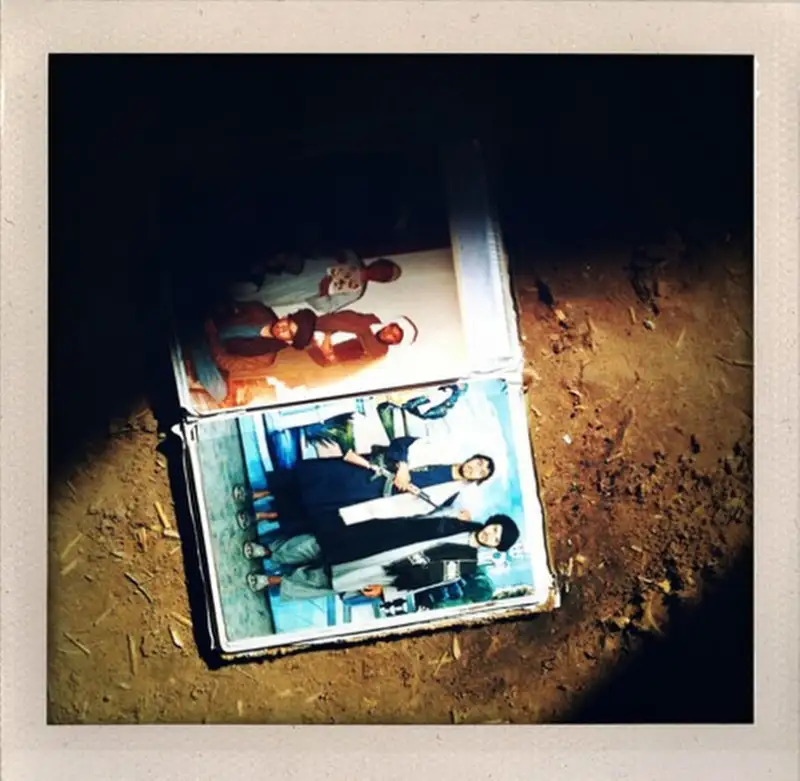 A book of photos of young men that U.S. Marines suspected of being Taliban members lies on the floor of a compound that the Marines searched in Marjah in Afghanistan's Helmand province.