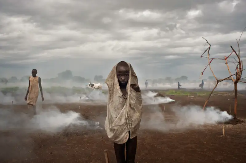 In the cattle camp of Bir-Diak, Rumbek North Country, Lakes State, cow dung is being burned to avoid insect bites to men and livestock.