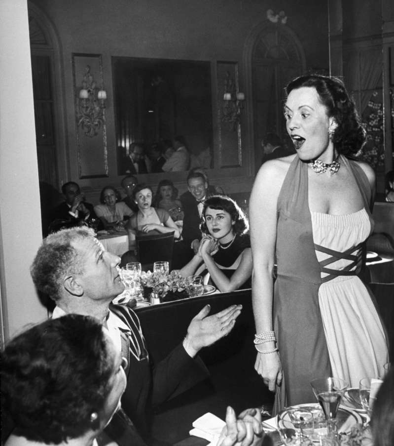 Veeck makes an impression on the famed Czech opera star Jarmila Novotna at a party in his honor given by Elsa Maxwell.