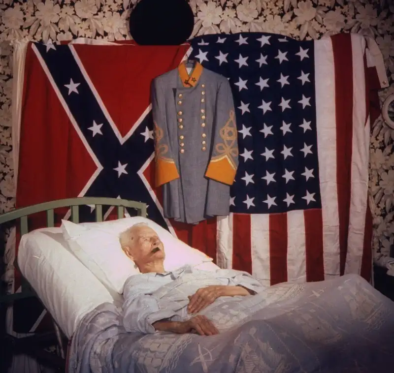 LIFE came to see Williams again in May 1959, seven months before his death, as his fame as the last living Civil War veteran grew: Flanked by the two flags he has loved and a dress version of a Confederate uniform, the last living veteran of the War between the States lies in an uptilted bed, sleeping mostly, waking to eat and puff an occasional cigar. By this time, Williams was living with a daughter — one of his 19 children — in Houston.
