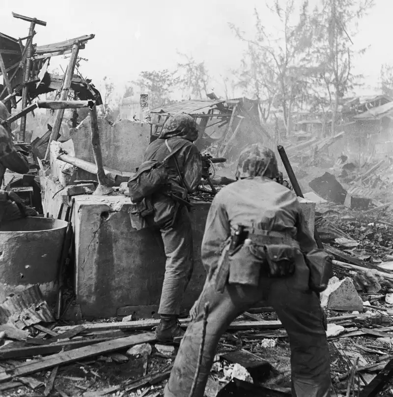 Under Fire
United States Marines advance on positions held by Japanese forces in Tanapag, Saipan, June 1944.