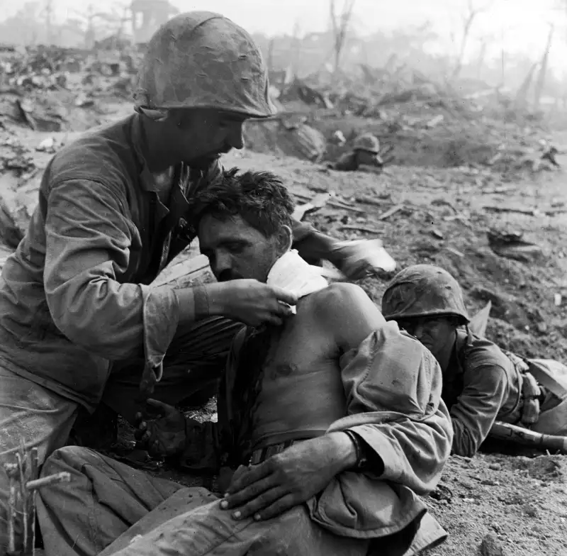 A Medic Treats the Wounded at Tanapag, Saipan
One of Smith's great strengths was an uncanny ability to convey a sense of immediacy even in the most extreme circumstances. Here a U.S. medic field-dresses a wounded serviceman during the month-long battle for Saipan.