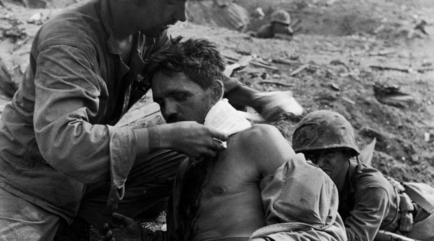 A Medic Treats the Wounded at Tanapag, Saipan
                      
                      One of Smith's great strengths was an uncanny ability to convey a sense of immediacy even in the most extreme circumstances. Here a U.S. medic field-dresses a wounded serviceman during the month-long battle for Saipan.