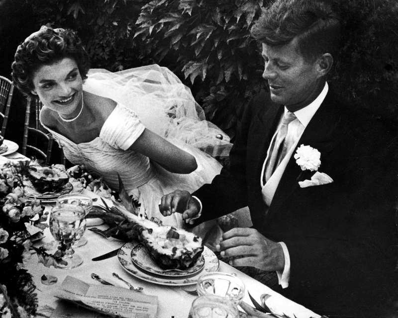 Jackie and JFK sit down to pineapple salad at their reception, held at Jackie's childhood home in Newport. Hammersmith Farm was the mansion and estate of Jackie's stepfather, Hugh Auchincloss.