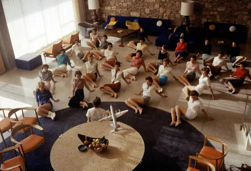 In 1958, aspiring stewardesses perform an exercise routine during a class at the American Airlines college for new flight attendants.