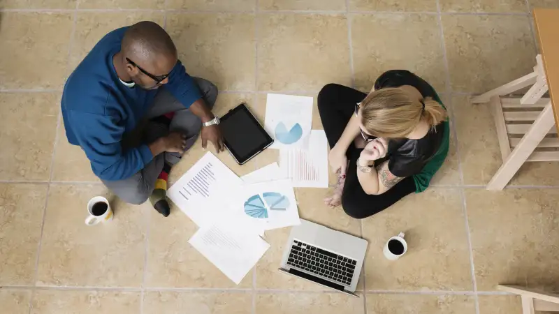 Millenials sitting on the floor discussing 401k investing