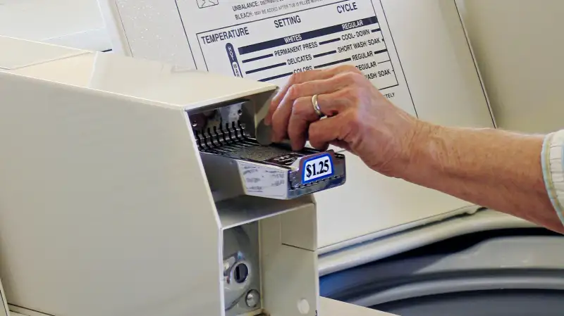 Putting quarters in laundry machine