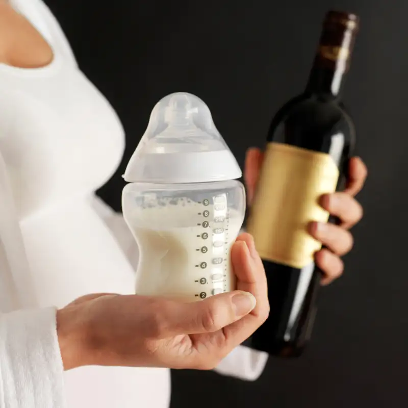 woman carrying milk bottle and wine bottle