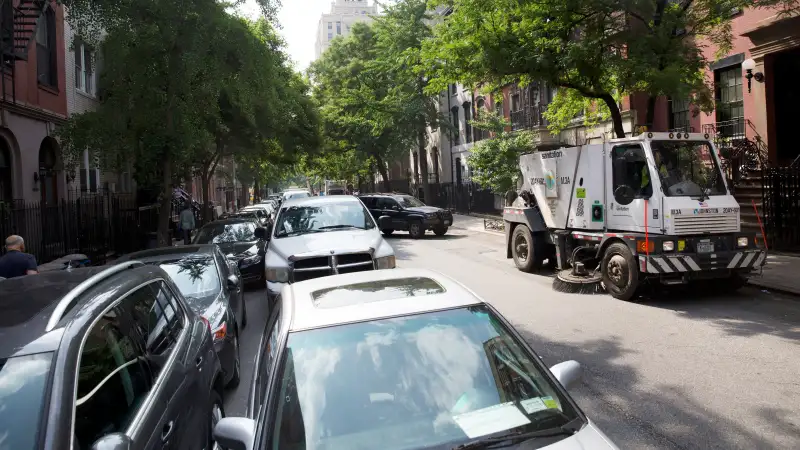 Double-parked cars on an alternate-side parking day