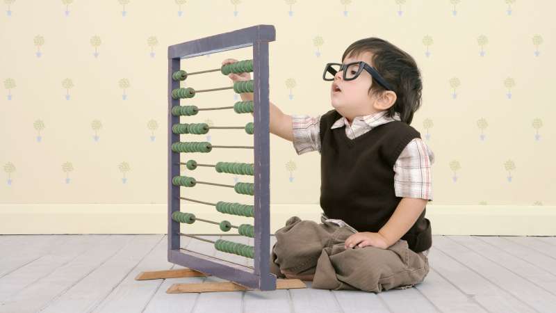 Kid learning to use abacus