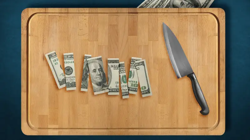 sliced dollar bill on cutting board