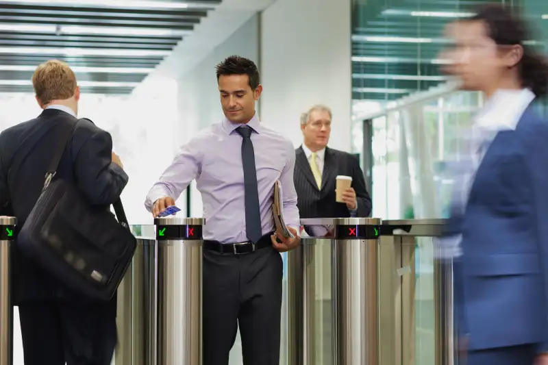 Employee walking through office building security gate