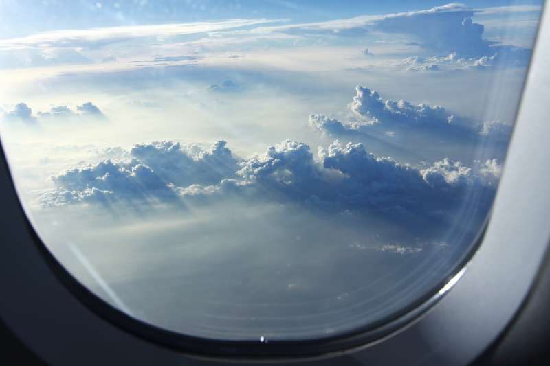 airplane window view above the clouds