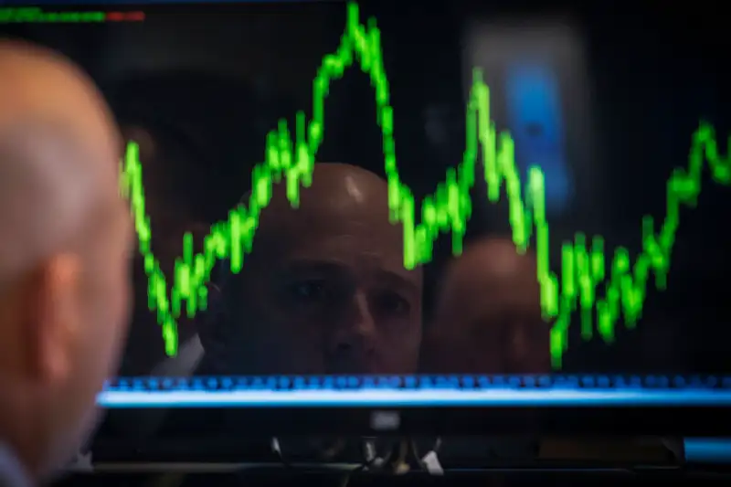 A Specialist trader watches his chart while working on the floor of the New York Stock Exchange