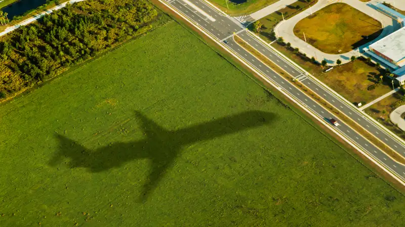 Airplane shadow over farmland