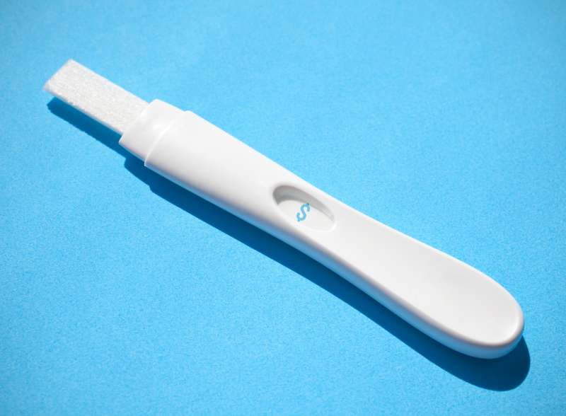 Pregnancy test with dollar sign