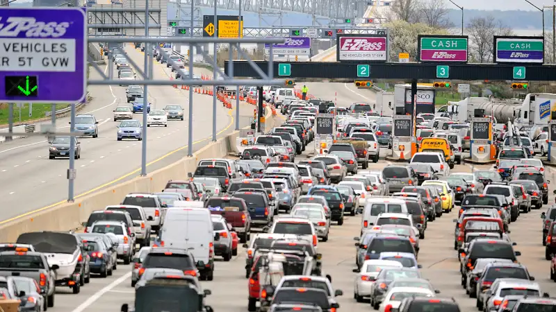 Line of cars waiting up at a toll