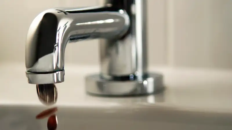 Faucet dripping coins