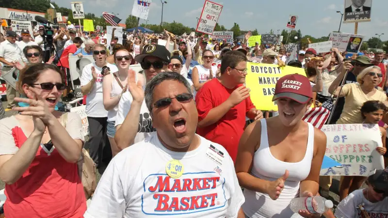 TEWKSBURY, MA - AUGUST 5: From left front, employees Ann Arsenault (grocery clerk), Larry Frost (head cashier) and Leighann Hodgkins (customer service), all from Billerica #17, cheer near the end of the rally. Market Basket employees, customers and supporters rally in Tewksbury, on Tuesday, August 5, 2014. (Photo by Pat Greenhouse/The Boston Globe via Getty Images)