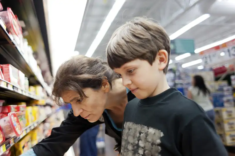 Single mother in her 40s at grocery store