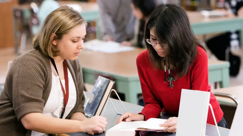 Librarian helping patron with book question