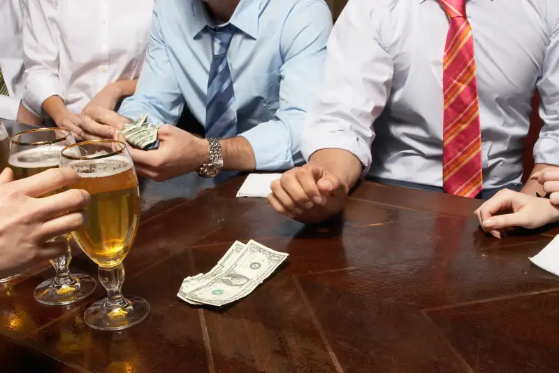 People paying for drinks at bar