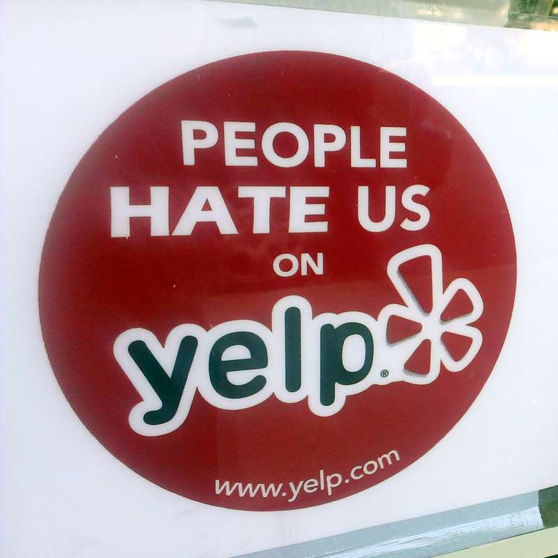 People Hate Us on Yelp poster in window