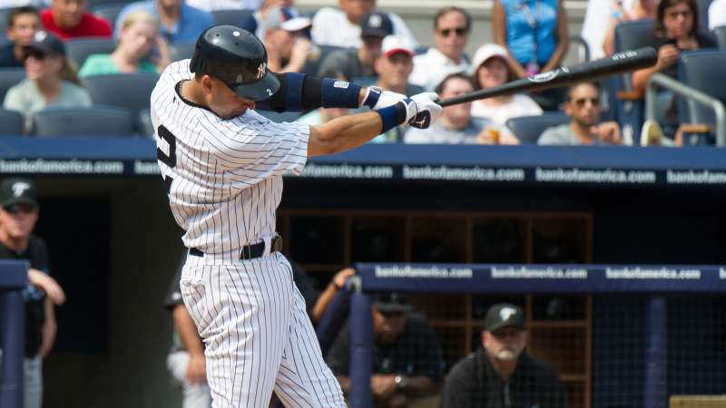 New York Yankees batter Derek Jeter follows through on his swing