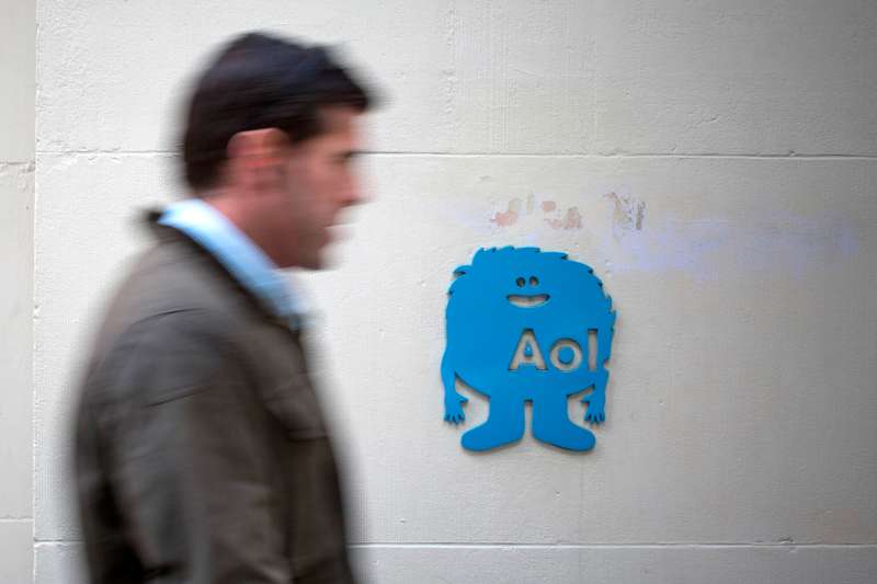 Man walking past AOL logo in NYC