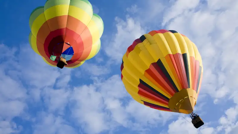 Hot air balloons floating higher and higher