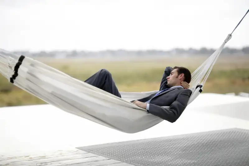 Man in business suit in hammock