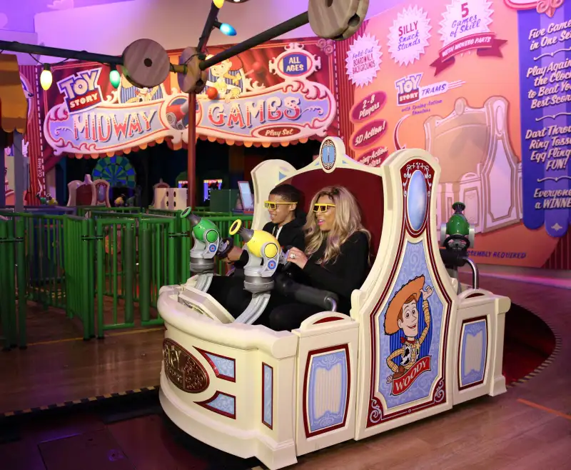 Daytime TV talk show host Wendy Williams and her son Kevin take a ride on  Toy Story Midway Mania!  during a visit to Disney's Hollywood Studios theme park at Walt Disney World Resort January 19, 2014 in Lake Buena Vista, Florida.