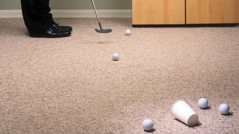 Practicing golf in office