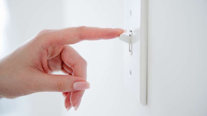 woman flicking light switch