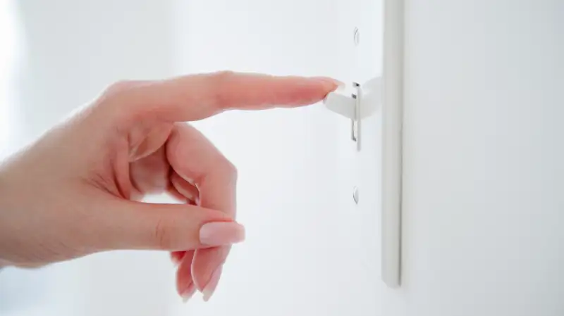 woman flicking light switch