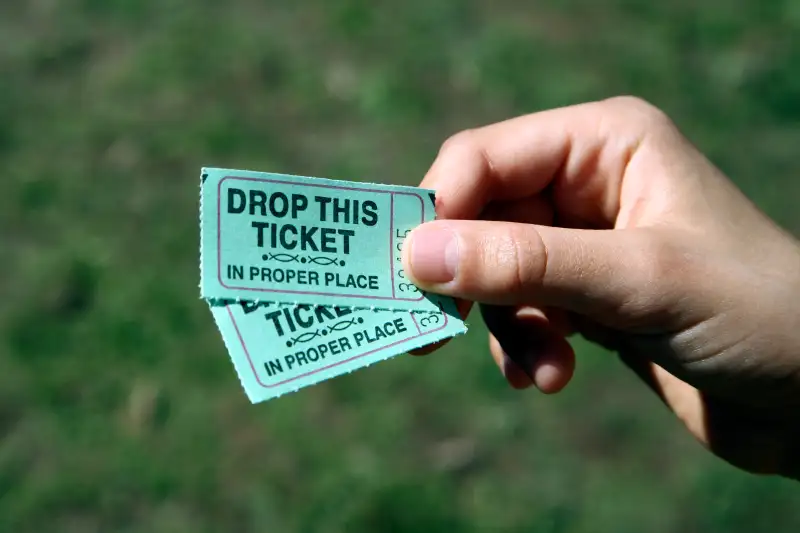 child's hand with ticket stubs