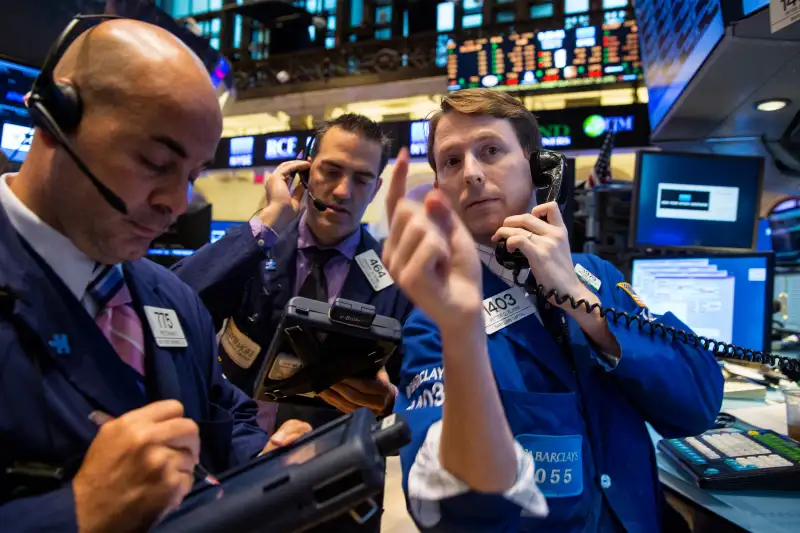 Traders work on the floor of the New York Stock Exchange October 15, 2014.