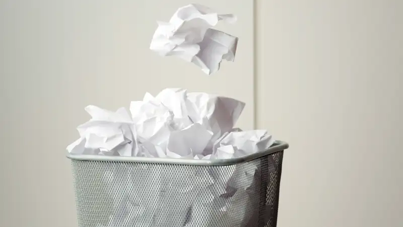 Throwing crumpled paper in wastebasket