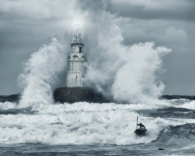 boats trying to ride out rough waves in ocean