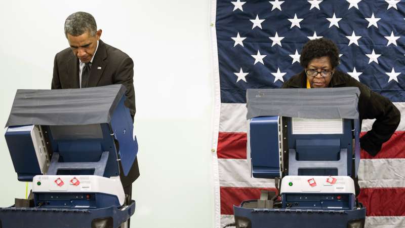 President Barack Obama(L) casts a ballot in early voting for the 2014 midterm elections at the Dr. Martin Luther King Community Service Center October 20, 2014 in Chicago, Illinois. The President took a break from campaigning for Democratic Governor Pat Quinn to cast his vote.