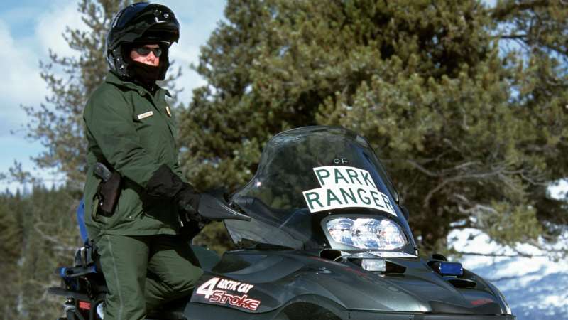 Ranger with snowmobile, Yellowstone National Park, Wyoming.