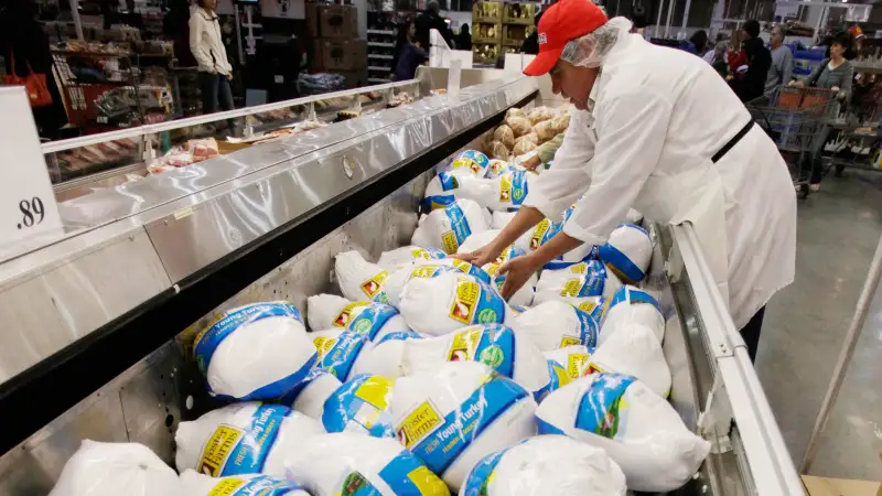 A Costco butcher organizes turkeys for sale at Costco Wholesale in Mountain View, California in preparation for Thanksgiving.