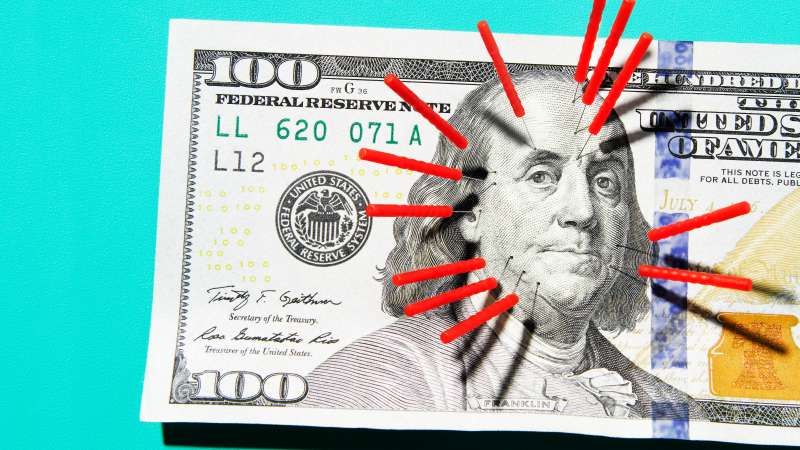 Acupuncture needles stuck in $100 bill