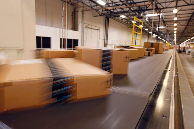 Amazon.com packages move along long conveyor belts at an Amazon.com Fulfillment Center.