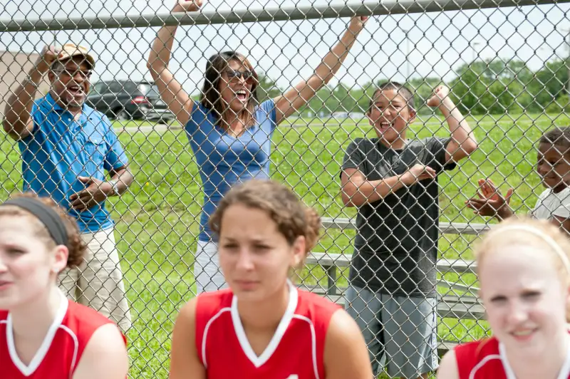 parents cheering softball players