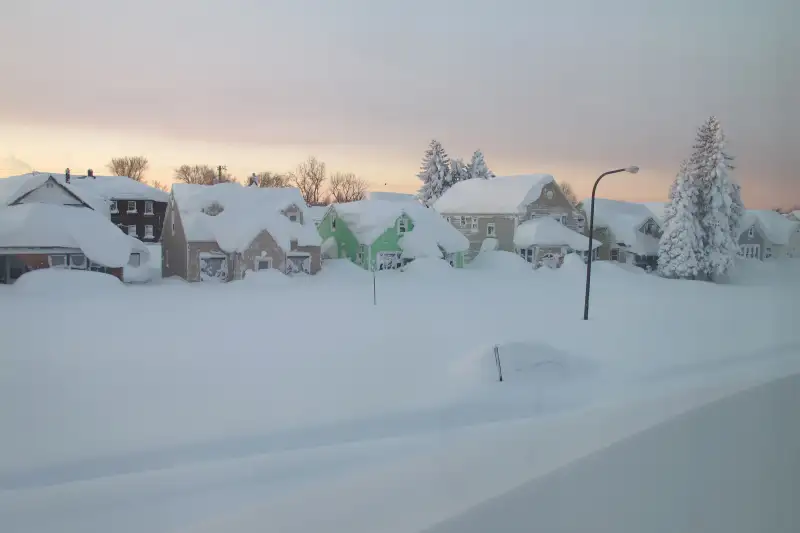 Snow covers a street at daybreak Wednesday, Nov. 19, 2014, in south Buffalo, N.Y.