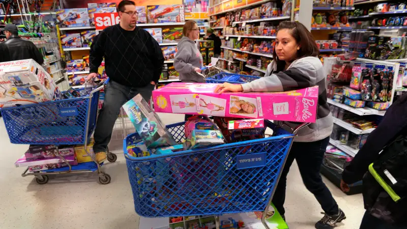 Jennifer Martinez filled a shopping cart with toys at the Toys R Us store on County Line Road in Arapahoe County Thursday night, November 28, 2013.