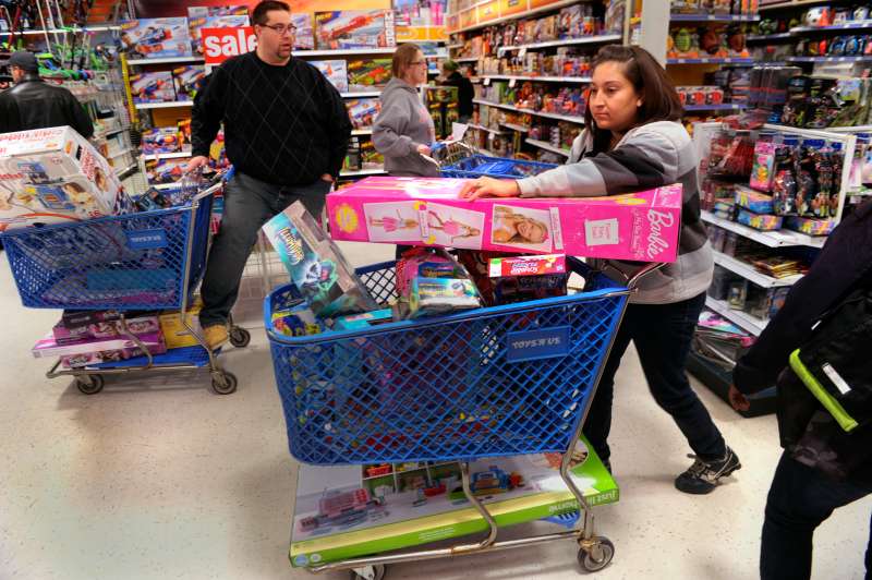 Jennifer Martinez filled a shopping cart with toys at the Toys R Us store on County Line Road in Arapahoe County Thursday night, November 28, 2013.